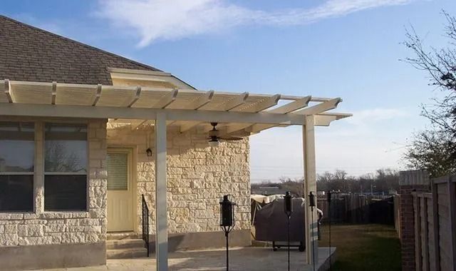 A house with a pergola on the front of it