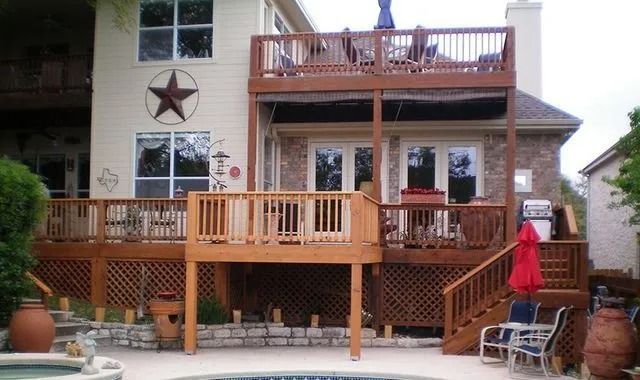 The back of a house with a wooden deck and stairs