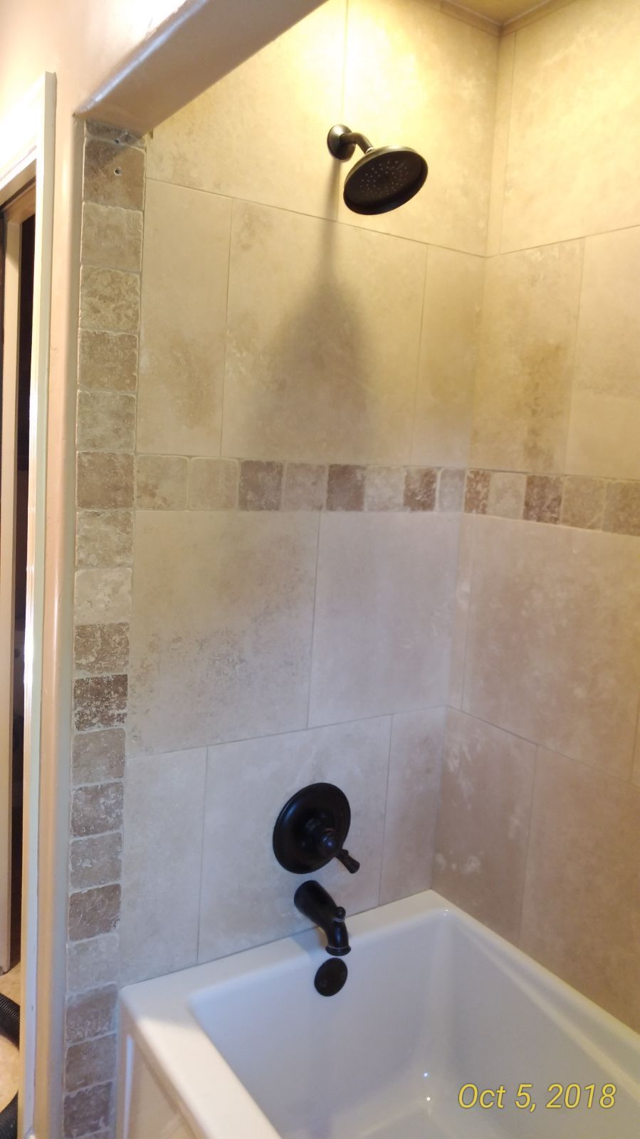 A bathroom with a bathtub and a shower.