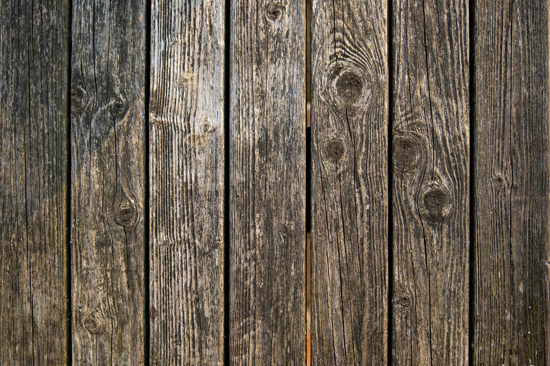 A close up of a wooden fence with a grainy texture.