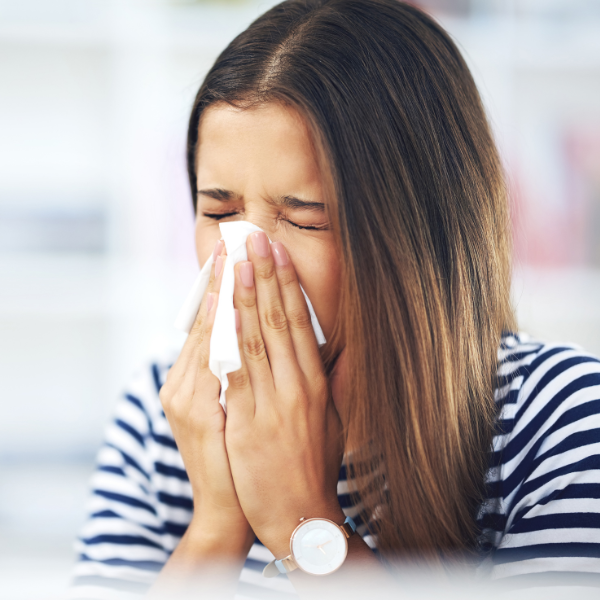 woman with allergies sneezing