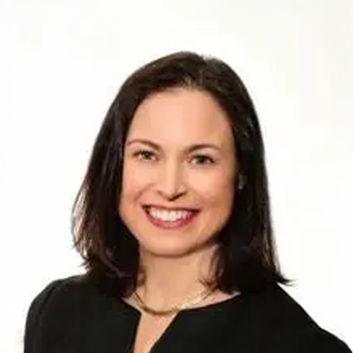 A woman in a black shirt is smiling for the camera.