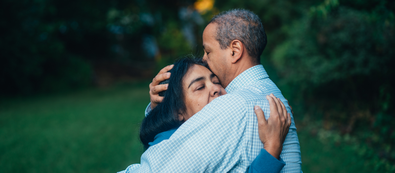 A man and a woman are hugging each other in a park. A man and a woman are hugging each other in a park.