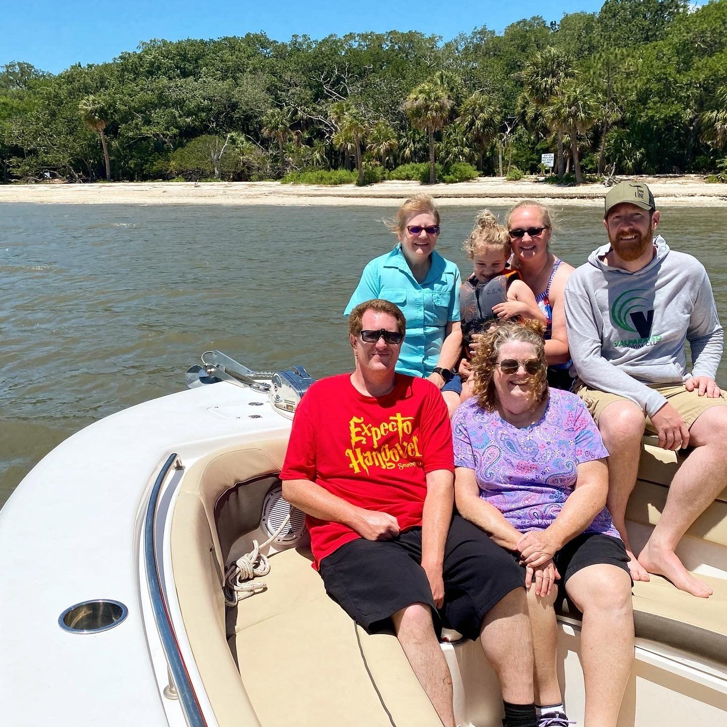 A group of people are sitting on a boat in the water