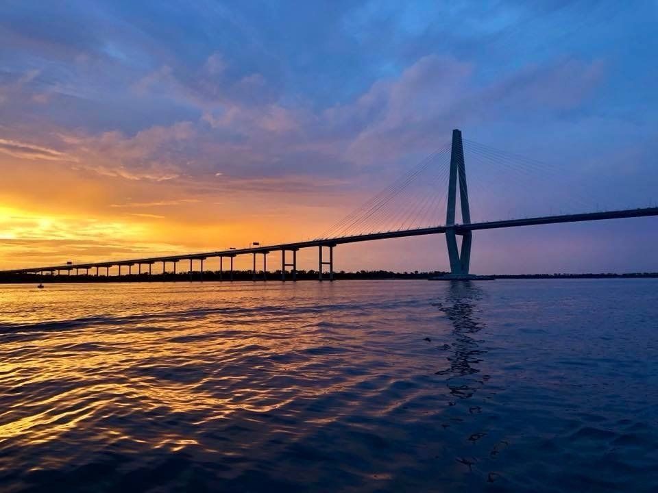 A bridge over a body of water at sunset