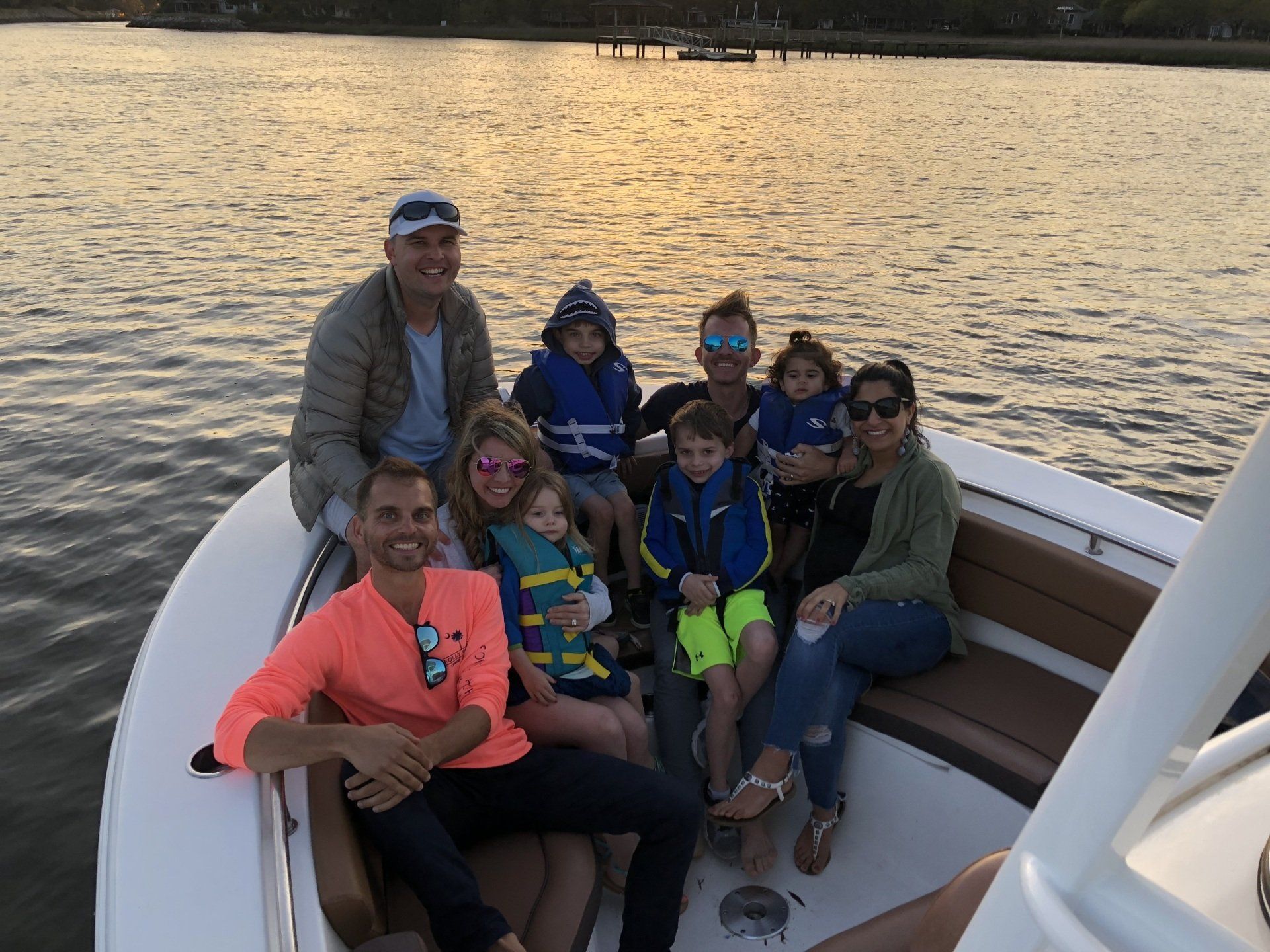 A group of people are sitting on a boat in the water.