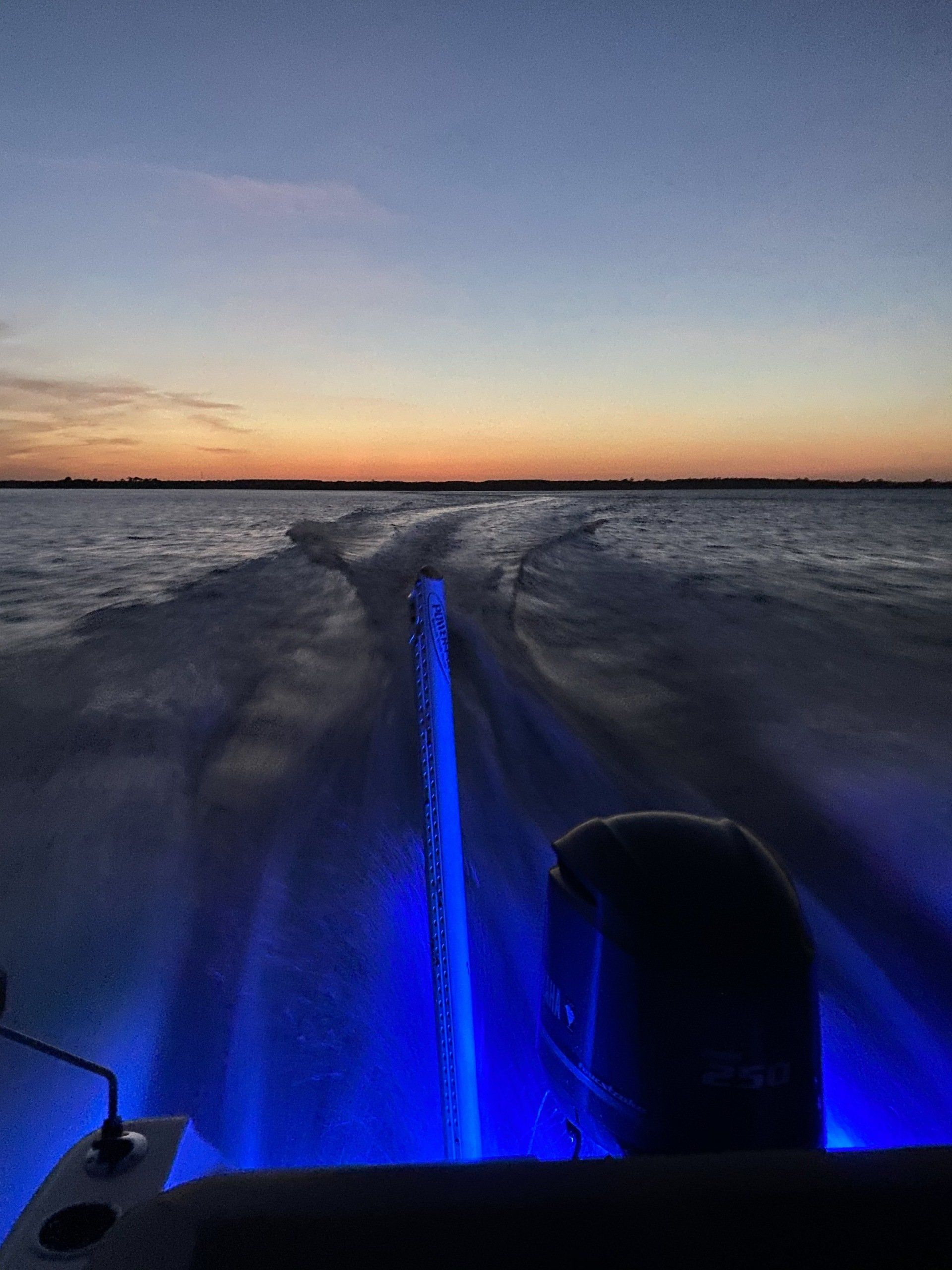 A boat with blue lights on the back of it