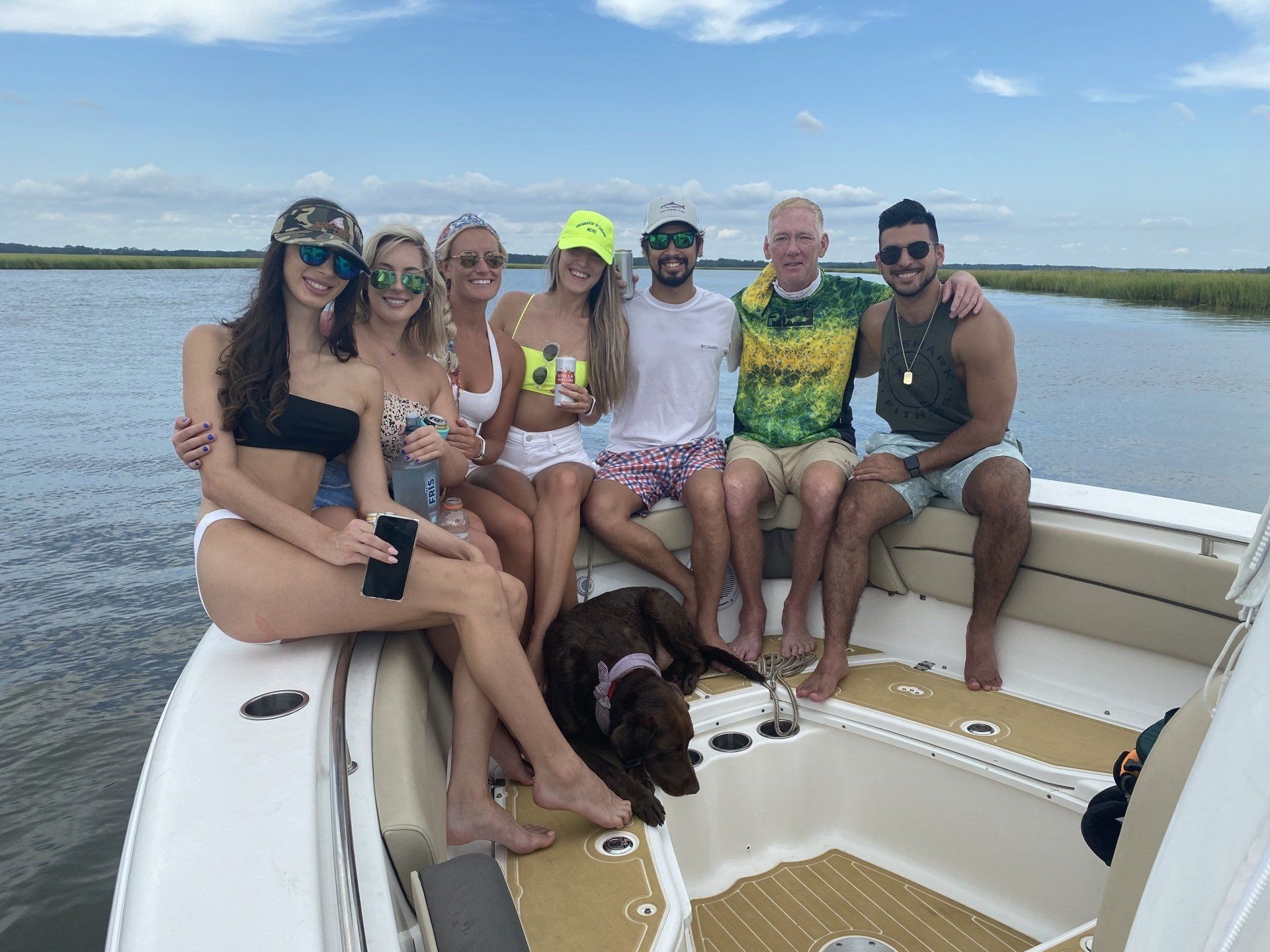 A group of people are sitting on a boat in the water.