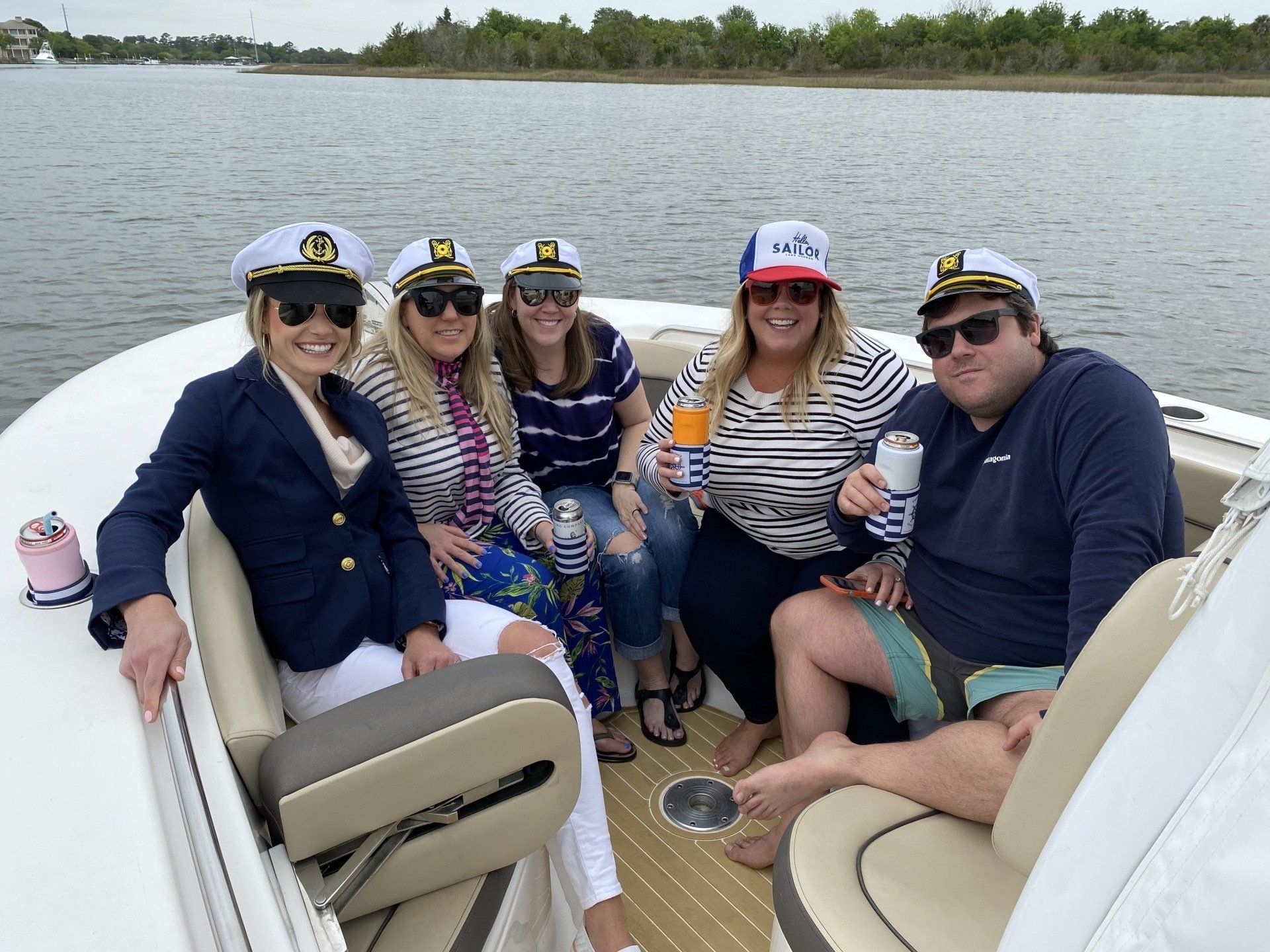 A group of people are sitting on a boat in the water.