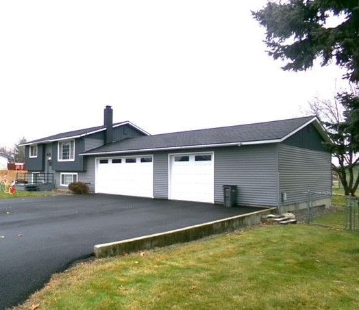 A house with a garage and a driveway in front of it