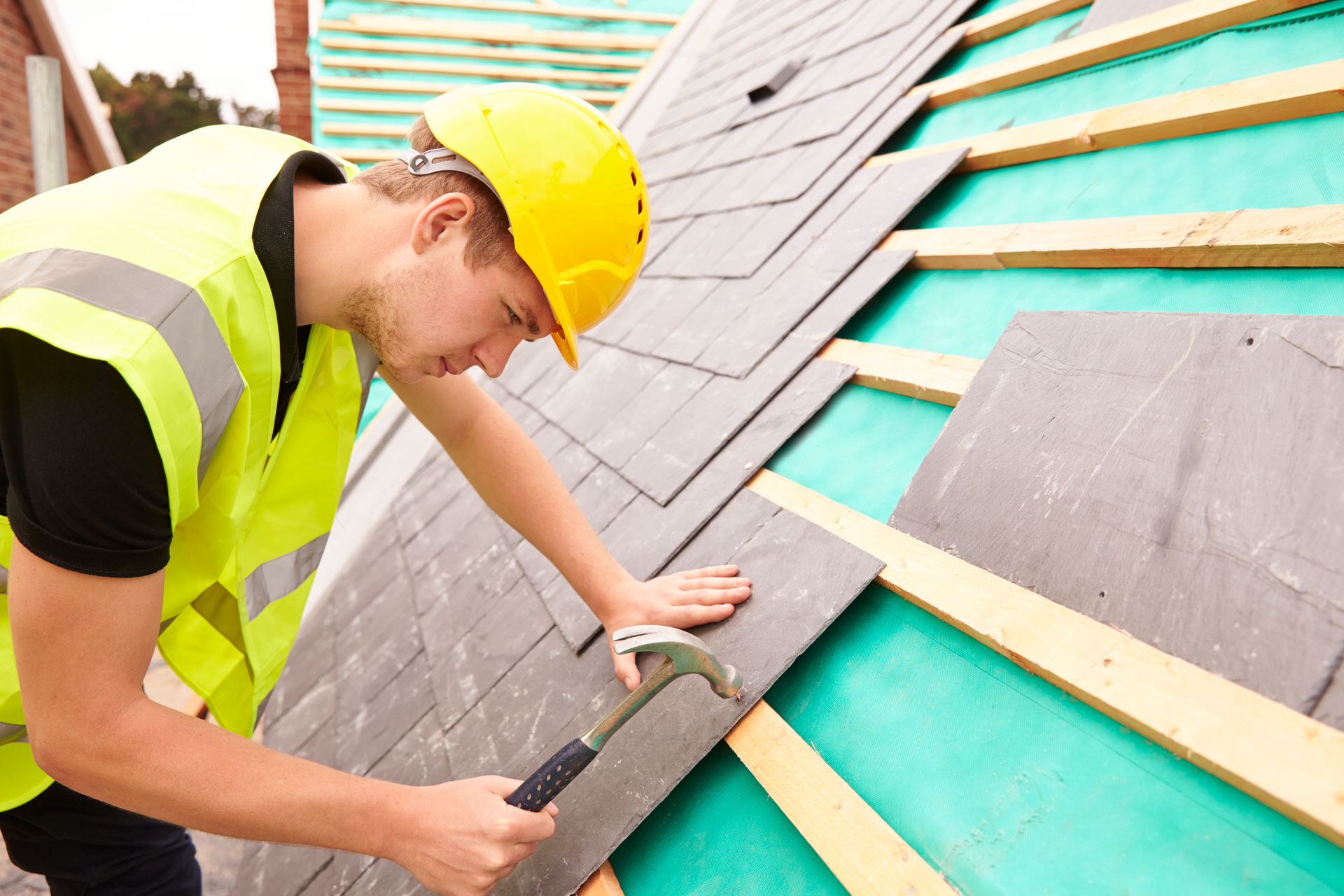 Construction Worker On Building Site Laying Slate Tiles |20/20 Exteriors