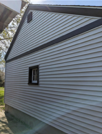 A recently completed Mastic vinyl siding job on the South Hill in the Grand Boulevard area - window