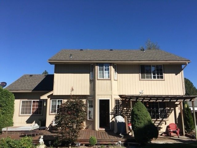 The back of a house with a pergola and stairs