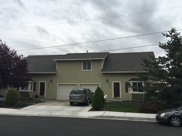 A house with a car parked in front of it