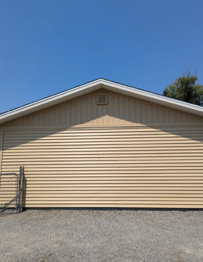 A tan house with a blue sky in the background