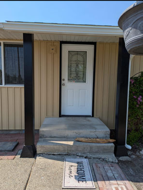 A white door with a welcome mat in front of it