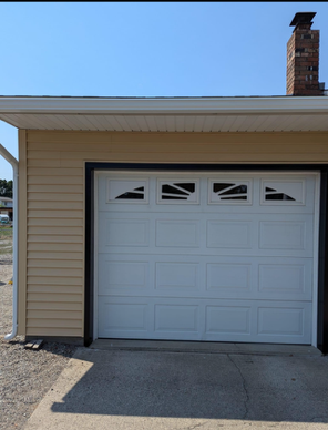 A white garage door with a chimney on top of it