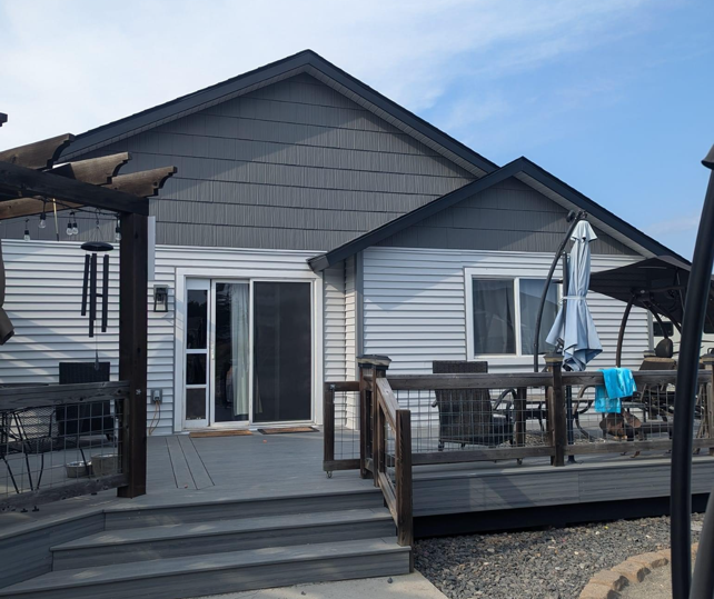 The back of a house with a deck and umbrellas