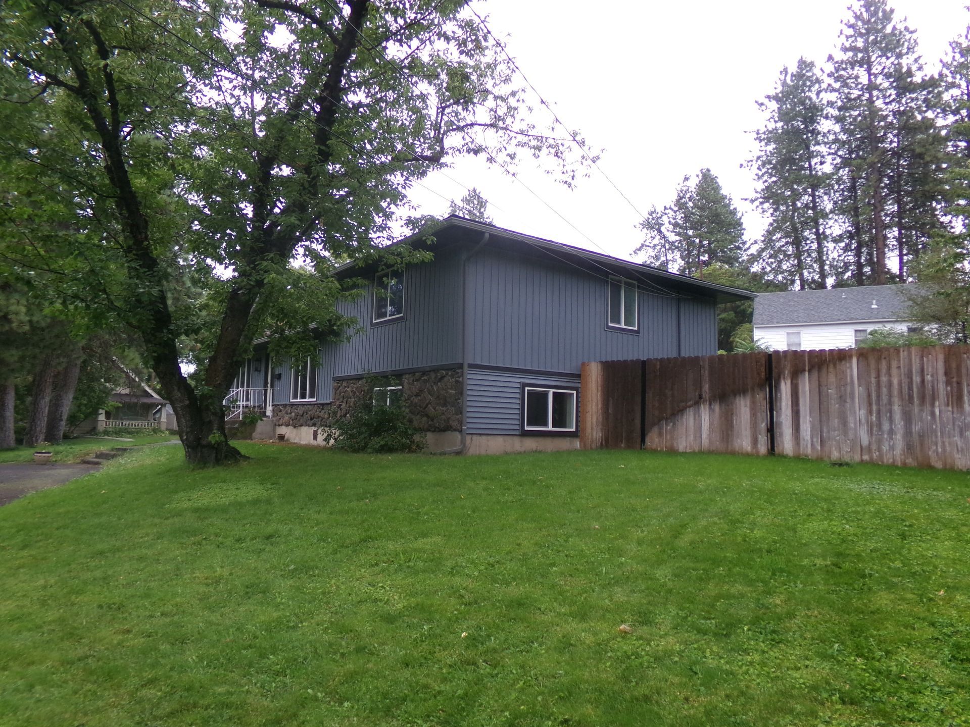 A house with a wooden fence in front of it