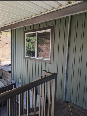 A house with a balcony and a window on the side