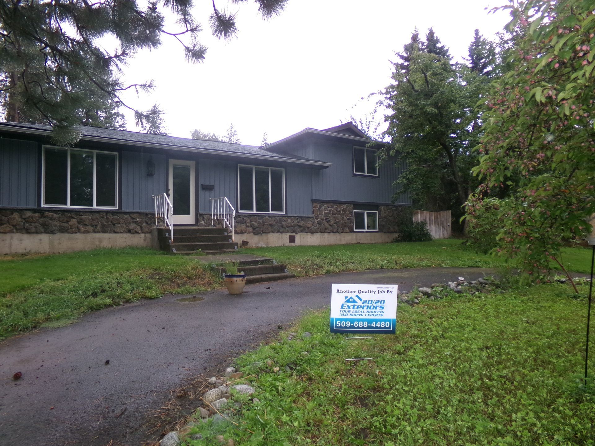 A house with a for sale sign in front of it