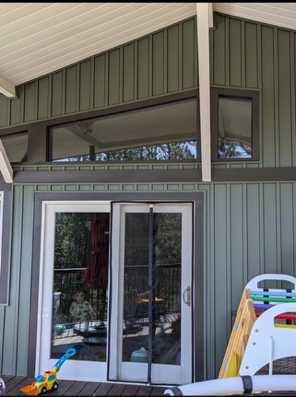 A house with a lot of windows and a sliding glass door