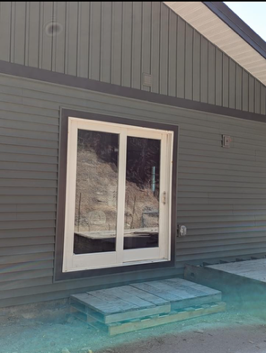 A house with a sliding glass door on the side of it