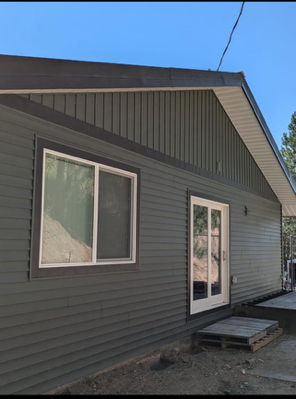 A house with a lot of windows and a sliding glass door.