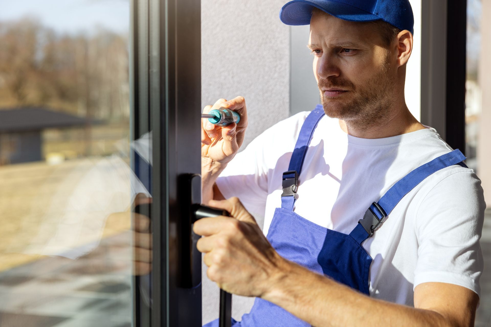 A sliding glass door repair specialist is installing and adjusting a frame sliding door.