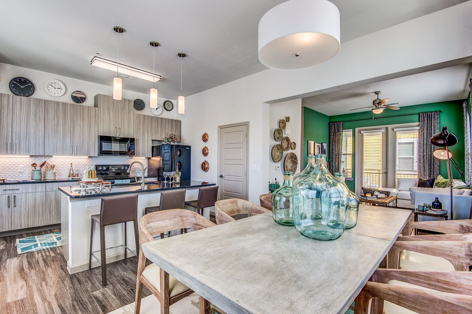 Apartments Lewisville TX - Hebron 121 Station - Modern Kitchen With Sleek Counters and Dining Room Table Equipped With Wooden Chairs