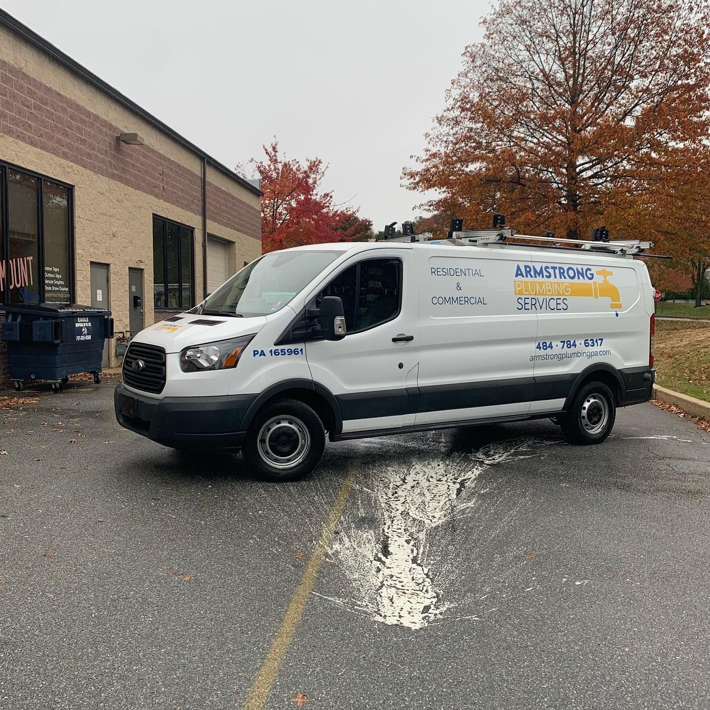 Side view of Armstrong Plumbing Services LLC service van