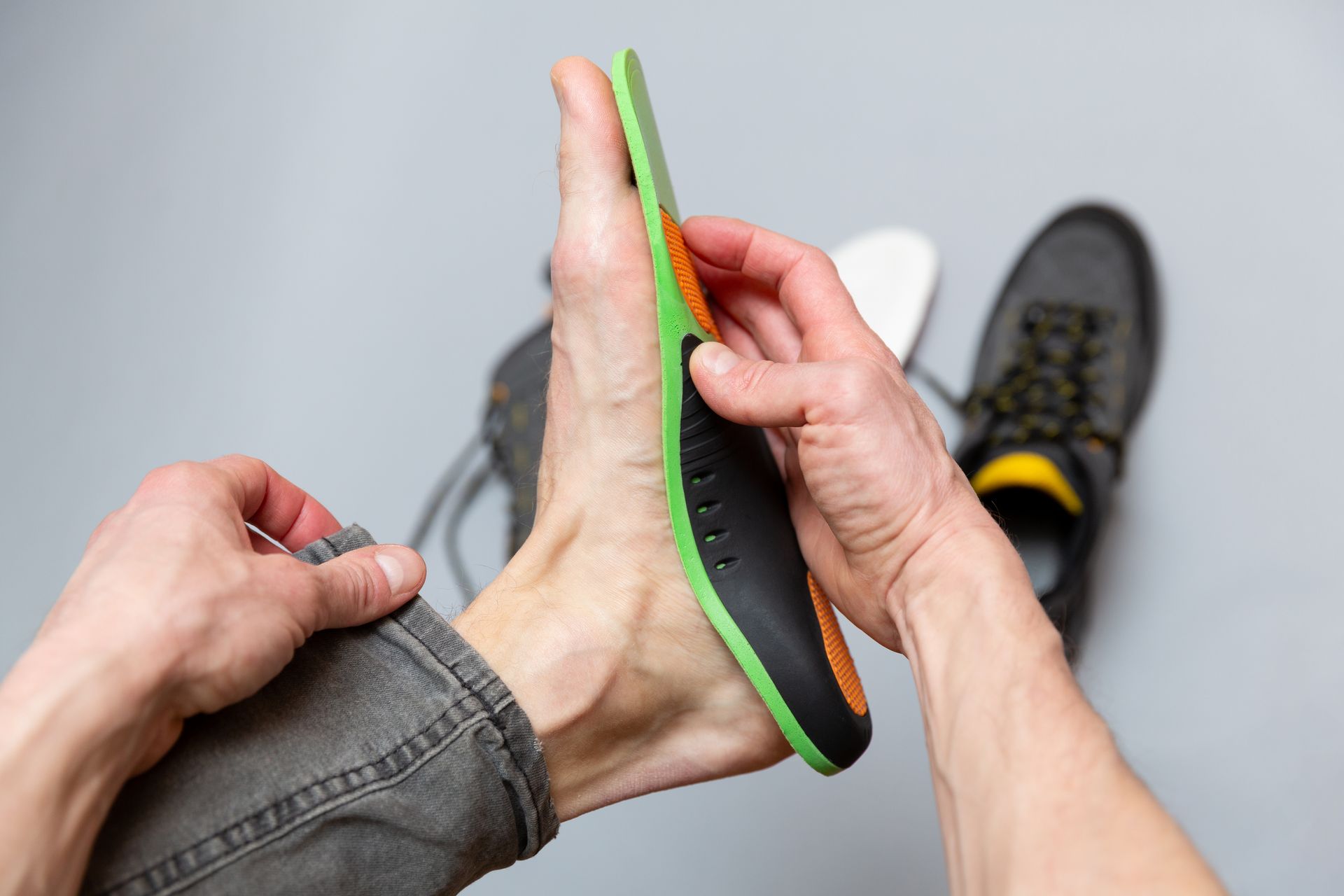 A person is putting a shoe insole on their foot.