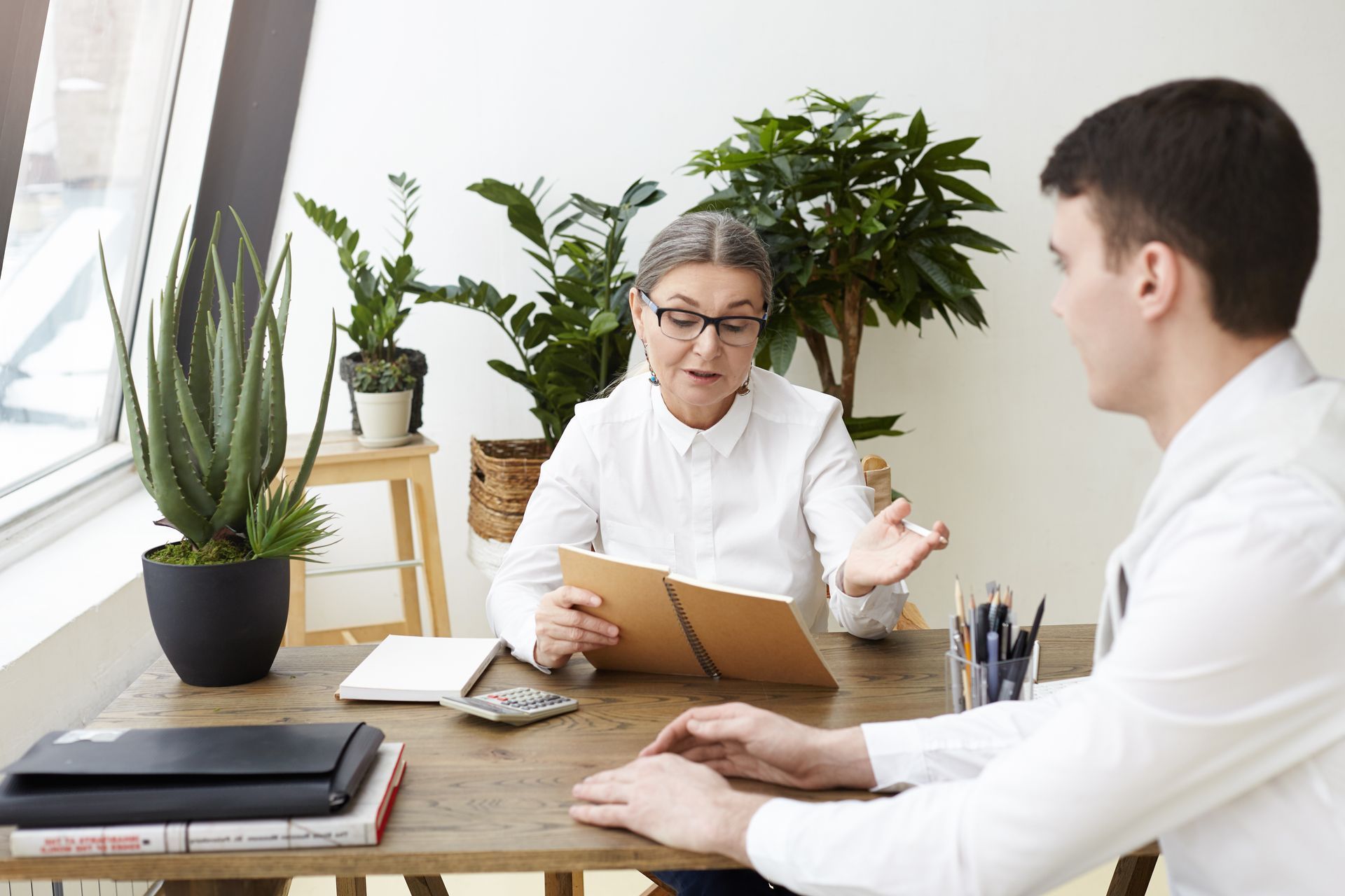 A man and a woman are sitting at a table having a conversation.