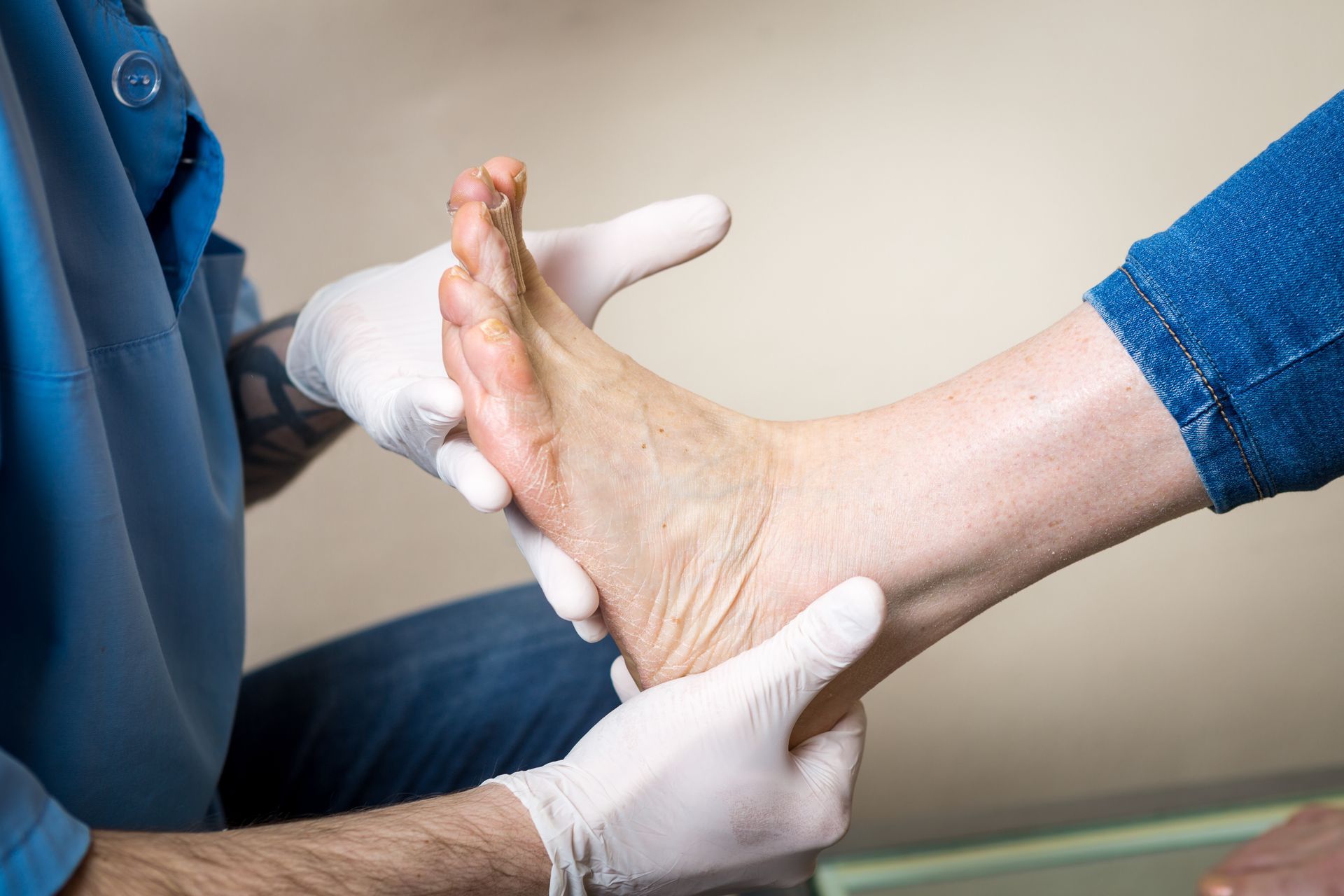 A person is getting their foot examined by a doctor.