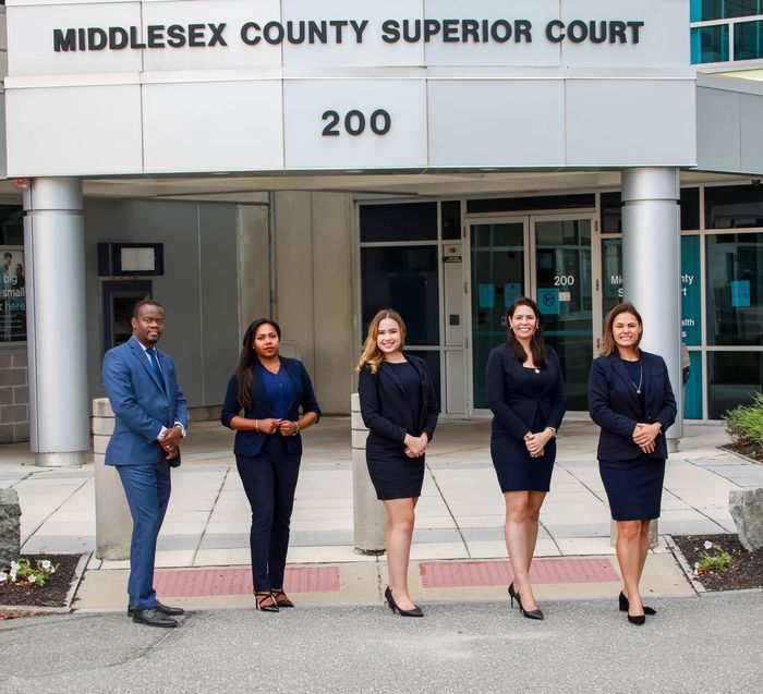 Group of lawyers in suits outside the Middlesex County Superior Court.