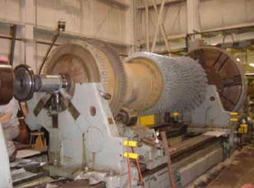 A large machine is sitting in a room in a factory.