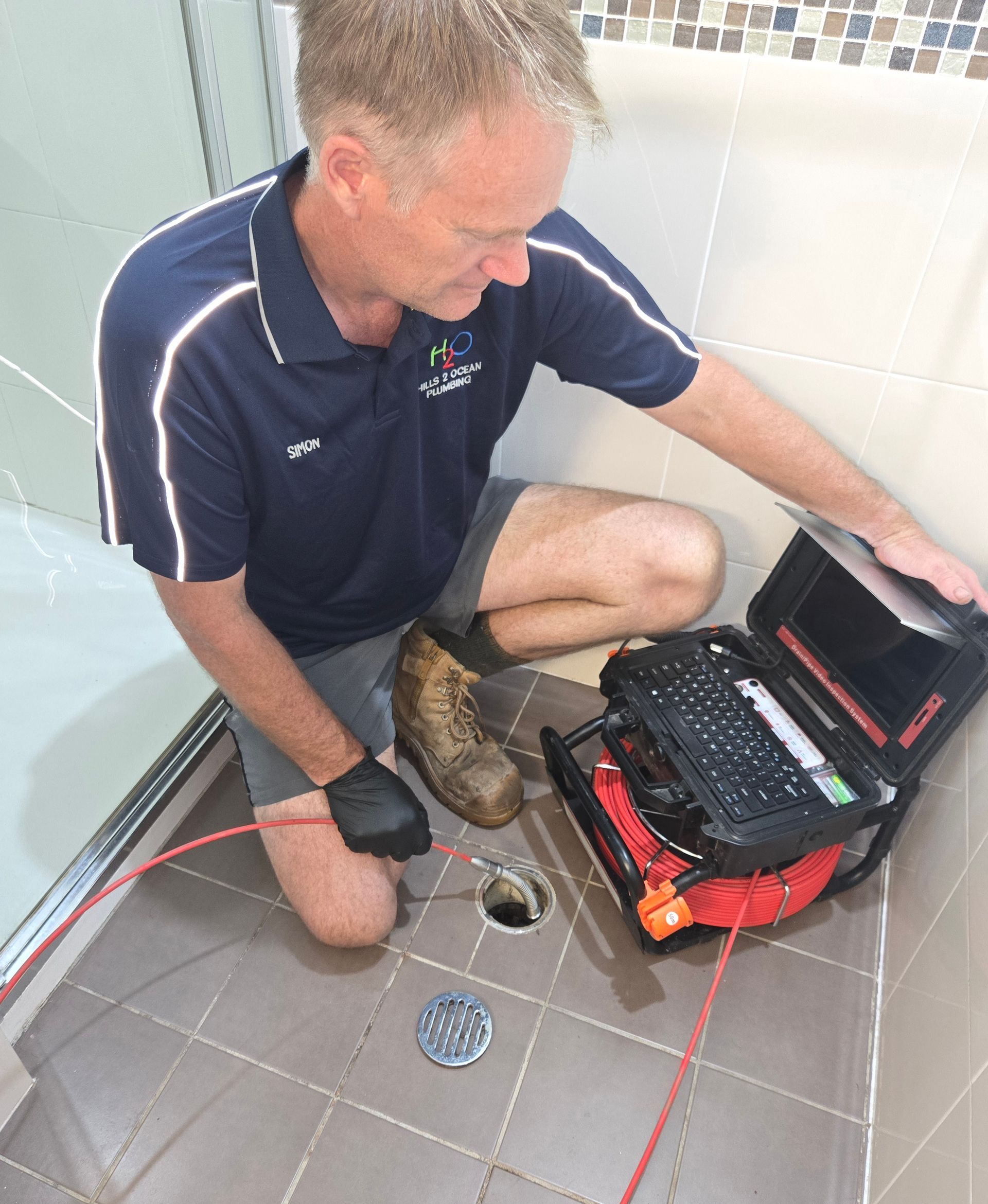 Plumber Inspecting a Shower Drain with A Camera — Hills 2 Ocean Plumbing in Iluka, NSW