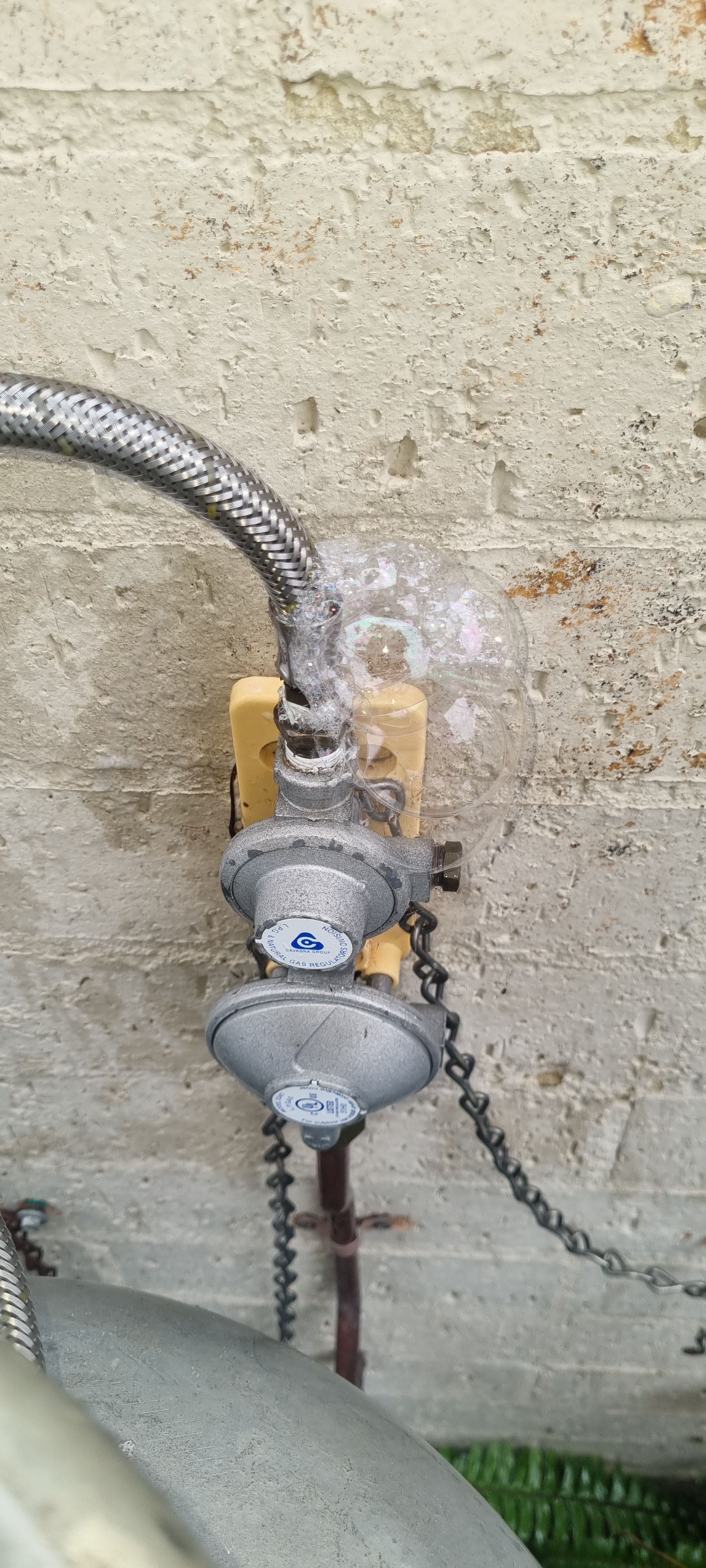 Metal Gas Regulator Connected to A Flexible Hose — Hills 2 Ocean Plumbing in Yamba, NSW