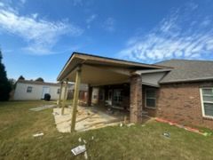 A house with a patio under construction on a sunny day.