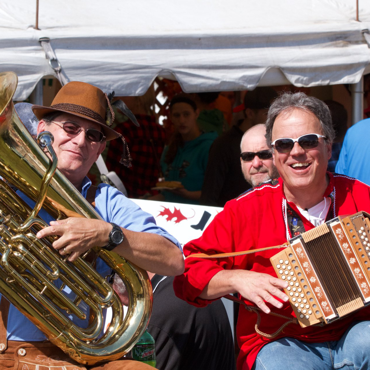 Men sitting on the Minster Oktoberfest float with instruments.