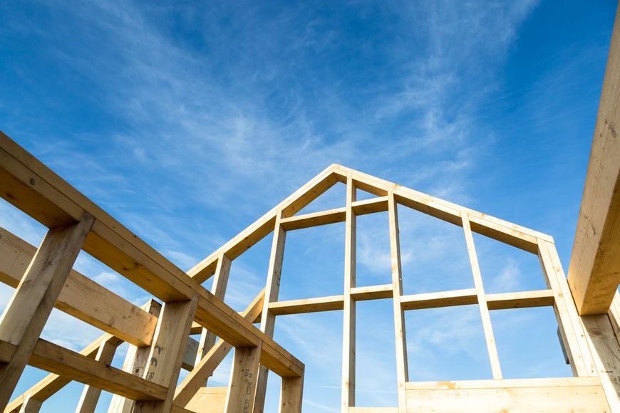 A house is being built with a blue sky in the background.