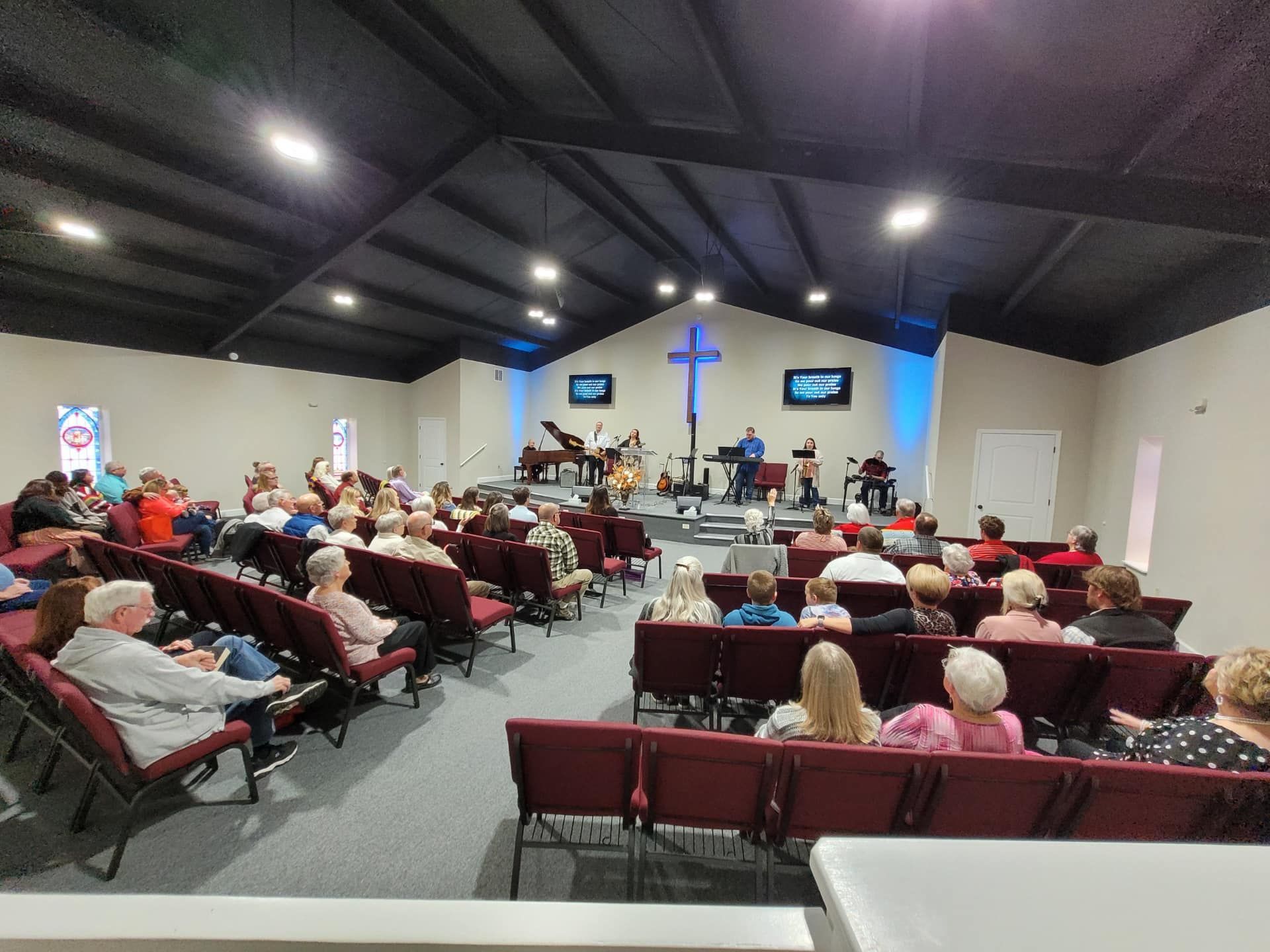 A large group of people are sitting in a church.