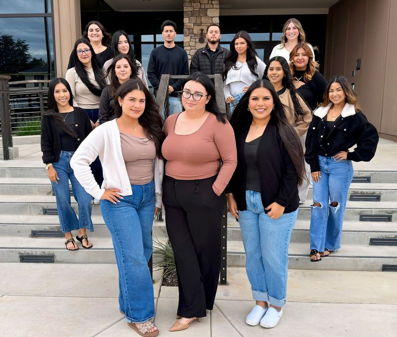a group of people are posing for a picture in front of a building