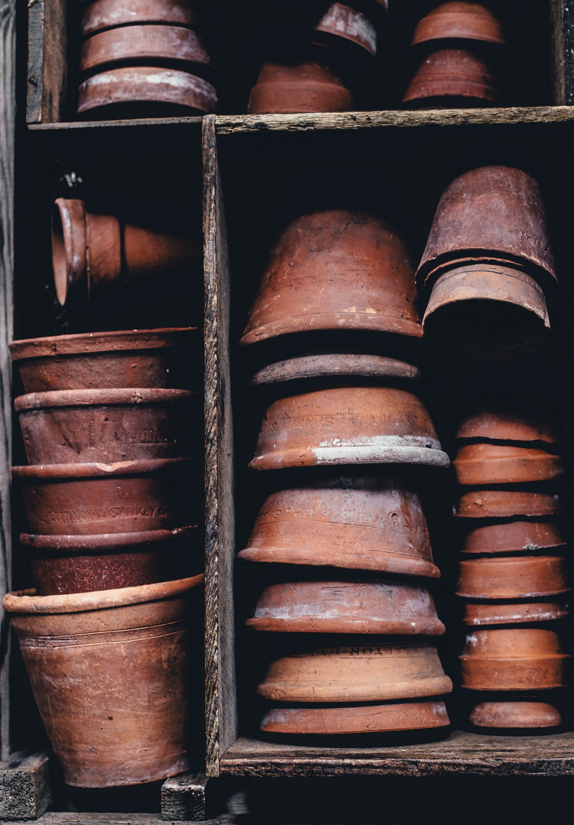 A shelf full of clay pots stacked on top of each other