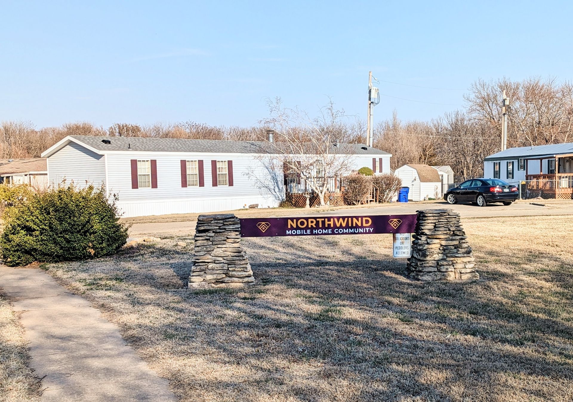 A mobile home park with a sign in front of it.