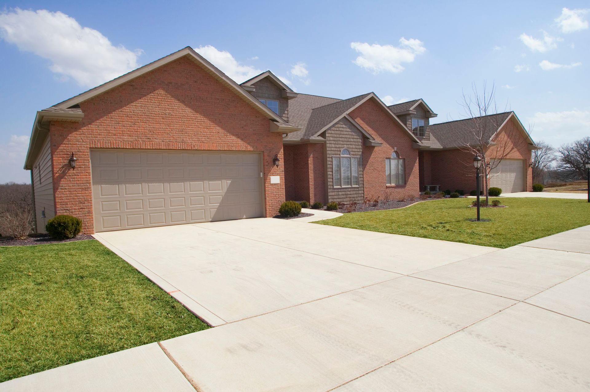 Modern brick home featuring a driveway and double garage doors in Sunshine Beach.