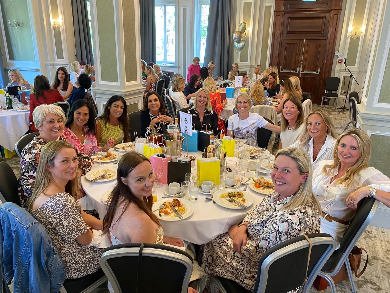 A group of women are sitting at a table  at a Friends of Alfie Martin charity lunch