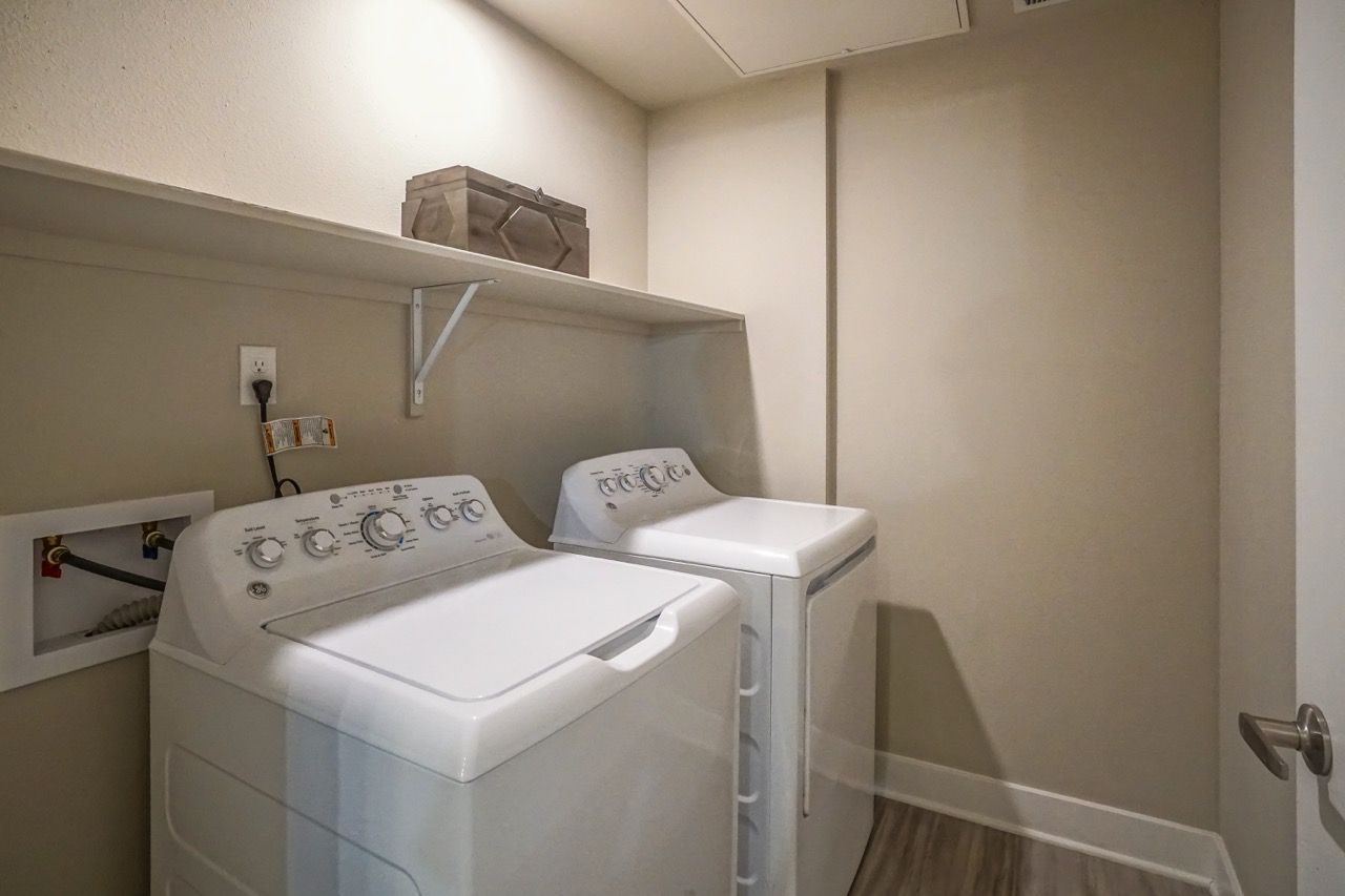 Laundry area with a washer and a dryer in a small closet.