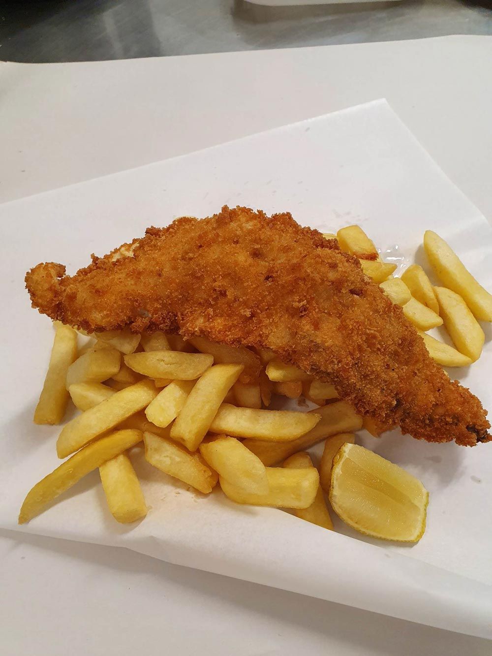 Crumbed Spanish Mackerel And Fries served with lemon — Local Seafood Shop in Portsmith, QLD