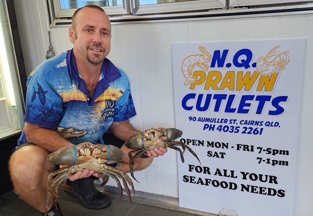 A Man holding Mud Crabs in his hands— Locally Caught Fresh Mud Crabs in Portsmith, QLD